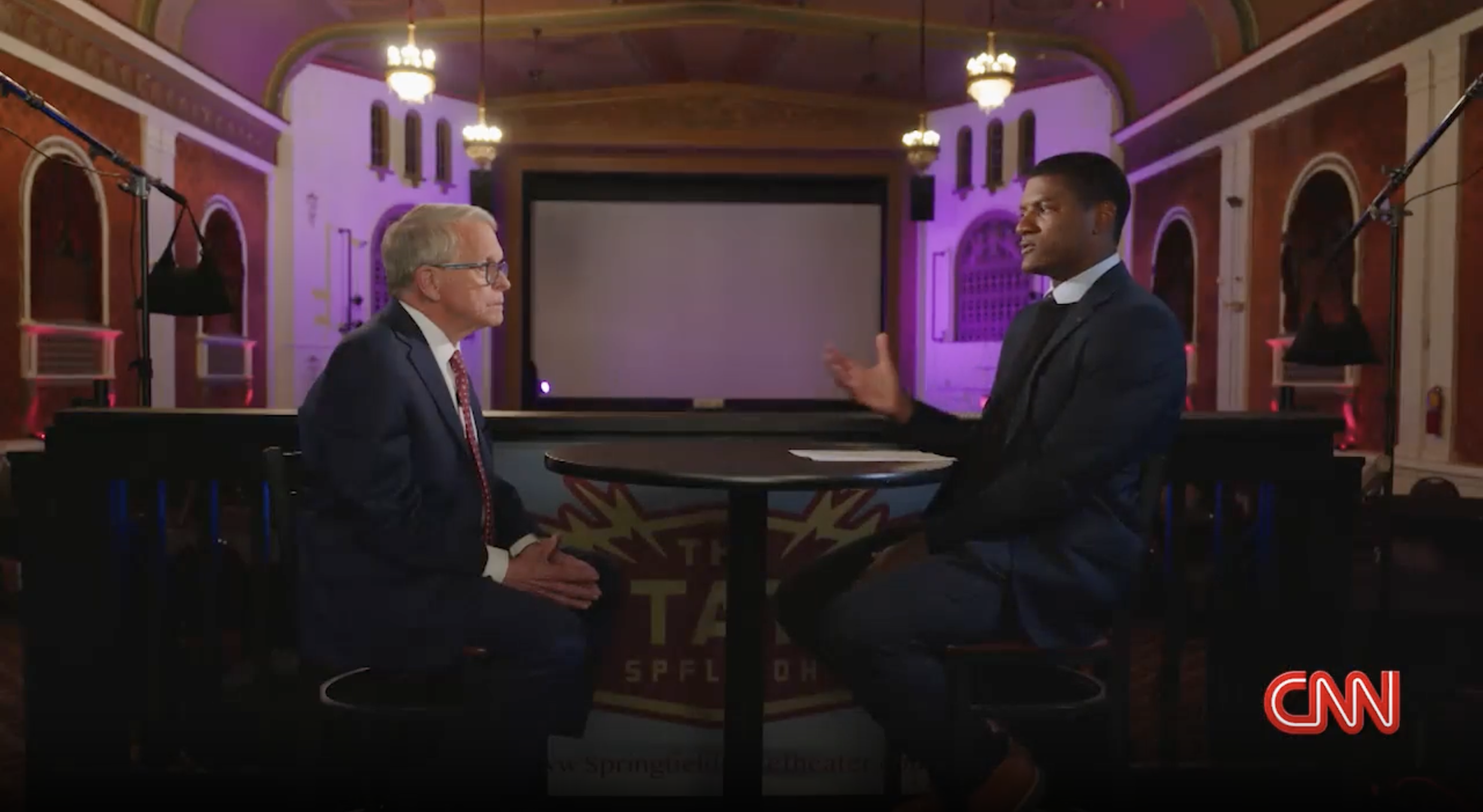 Two people converse on television