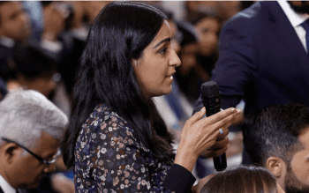 A person, Sabrina Siddiqui, speaks into a microphone